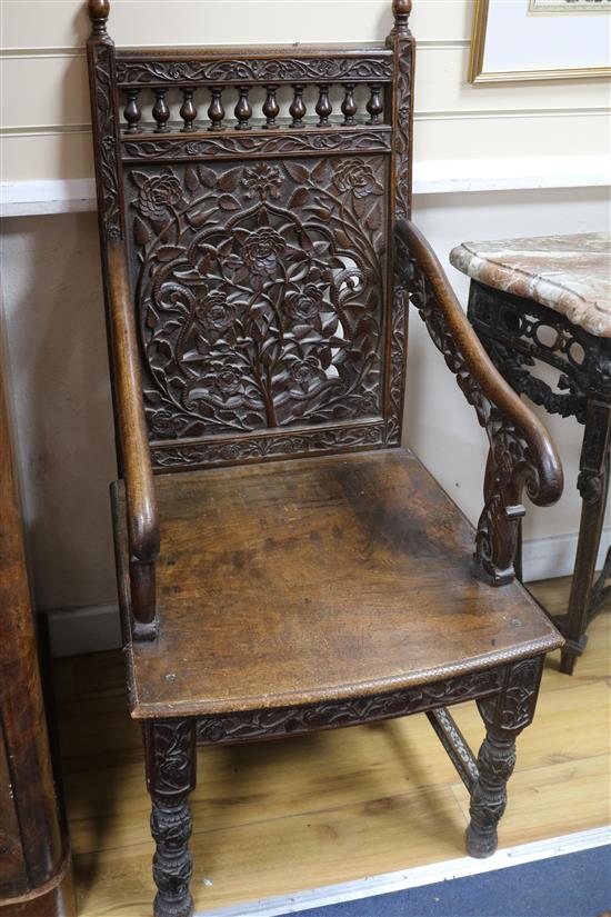 A pair of foliate carved armchairs